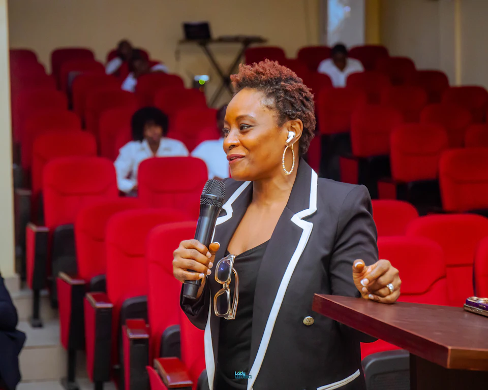 A woman leader addressing an auditorium